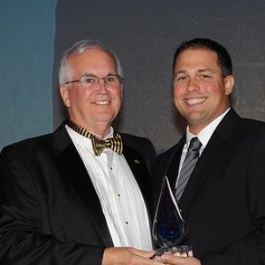FPRA members posing together, one holding an award