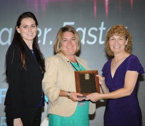 Presidents Awards plaque held by two FPRA members