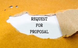 The words "Request for Proposal" revealed under ripped cardboard