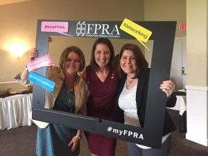 Three FPRA posing behind FPRA cutout with #thinkFPRA, Professional Development, #FPRATraditions and Networking bubbles