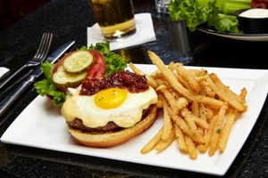 MSG Market Burger with fried egg and fries on the side