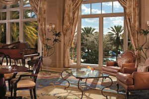 Lobby lounge with windows overlooking palm trees