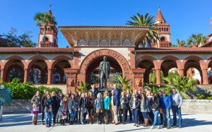 Large group of CN members posing together outside in front of Flagler College entryway