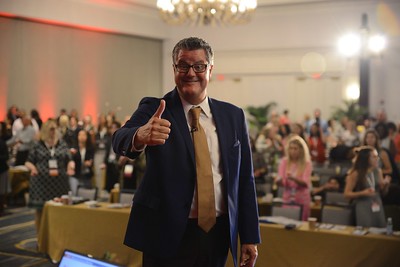 Virtual conference recorded general sessions, FPRA member turning around and giving a thumbs up with FPRA members behind him