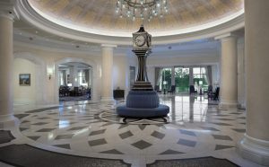 Waldorf Astoria Orlando lobby with a circular, center couch and clock tower
